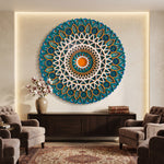 A large circular mandala wall art piece in teal, blue, white, and orange hangs on a beige wall above a dark wood console in a styled living room with armchairs and a rug. image 1