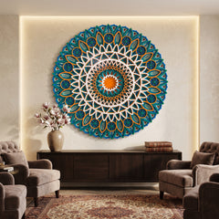A large circular mandala wall art piece in teal, blue, white, and orange hangs on a beige wall above a dark wood console in a styled living room with armchairs and a rug.