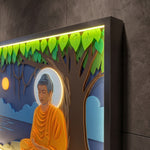 A framed wall art piece featuring a stylized Buddha seated under a tree with glowing green leaves and warm ambient lighting along the top frame, shown against a dark textured wall. image 6