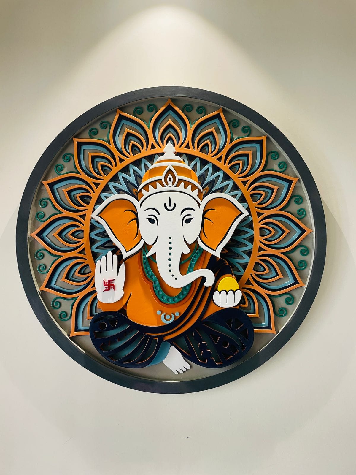Multi-Layered Lord Ganesha Wooden Mandala Frame shown in a room